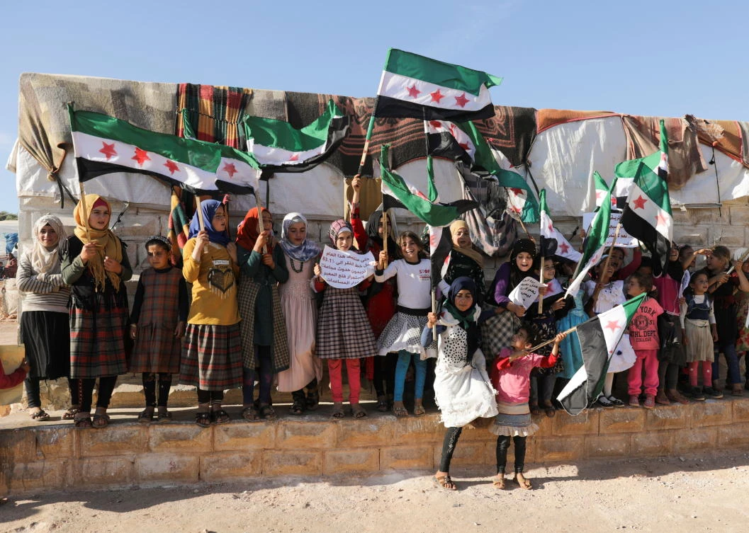 Syrian refugee girls protest the closure of Bab al-Hawa crossing in Idlib, Syria. RefuSHE, a Nairobi-based humanitarian agency, was conferred the 2021 Sharjah International Award for Refugee Advocacy and Support (SIARA) on Monday. (Reuters)