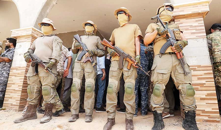 Libyan Government of National Accord fighters stand guard at the reopening of a road between Misrata and Sirte. (AFP)