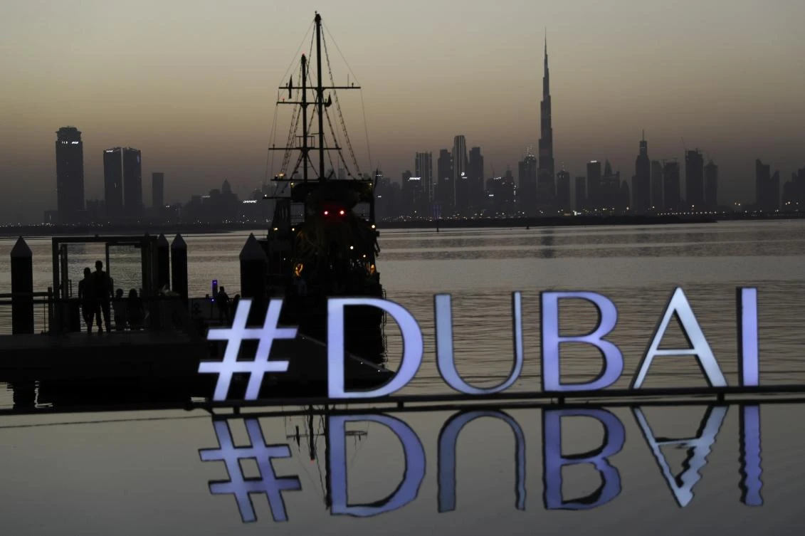 People embark on a dinner dhow cruise in Dubai. The emirate's sovereign wealth fund on Tuesday announced a net loss of $5.1 billion over the past year. (AP)