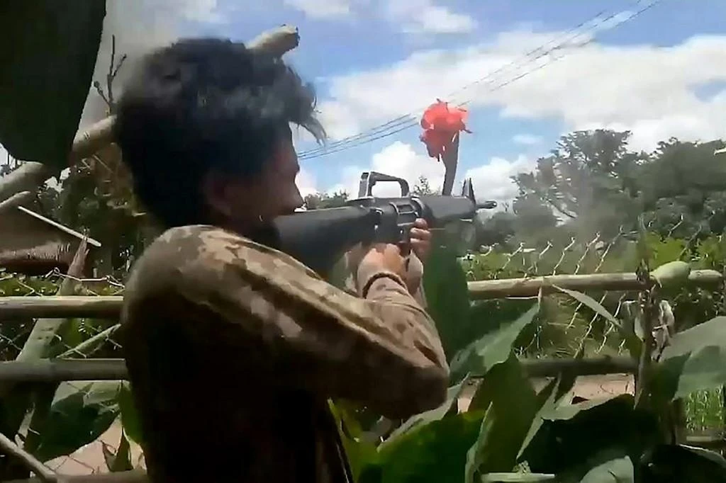 Above, a screengrab from a May 23, 2021 video shows a People’s Defense Force fighter during clashes against Myanmar security forces. (AFP)