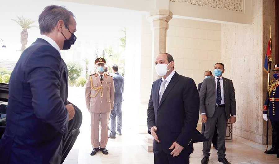 Egyptian President Abdel Fattah El-Sisi receives Greek Prime Minister Kyriakos Mitsotakis ahead of their meeting in Cairo on Tuesday. (AP)