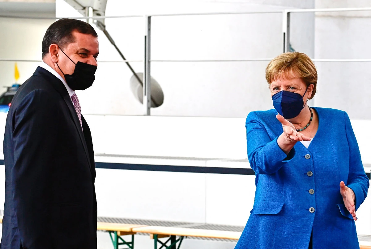 German Chancellor Angela Merkel welcomes Libyan Prime Minister Abdulhamid Dbeibeh at the sidelines of the second Libya summit in Berlin on June 23, 2021. (REUTERS/Michele Tantussi)