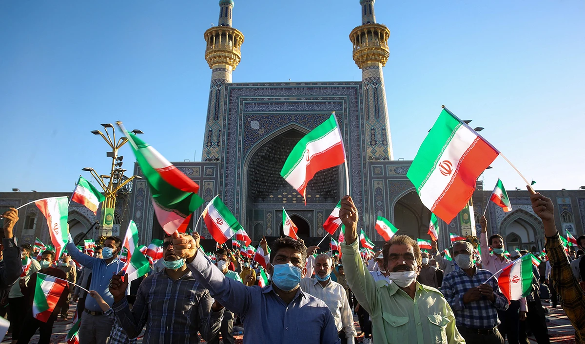 Supporters of Iran's President-elect Ebrahim Raisi cheer at the Imam Reza shrine in the city of Mashhad in northeastern Iran, on June 22, 2021. (AFP)