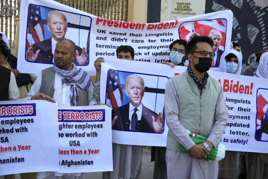 Former Afghan interpreters hold placards during a demonstration against the US government, in front of the US Embassy in Kabul on Friday. (AP)