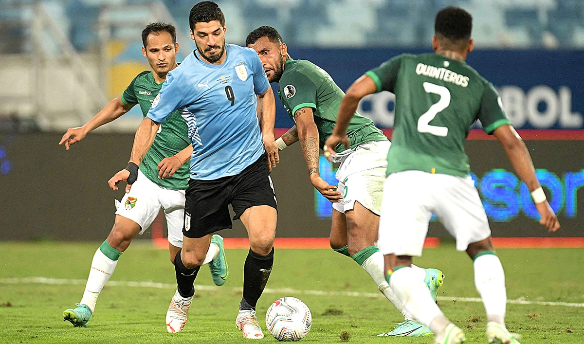 Uruguay's Luis Suarez is marked by Bolivia's players during their Conmebol Copa America 2021 football tournament group phase match at the Arena Pantanal Stadium in Cuiaba, Brazil, on June 24, 2021. (AFP)