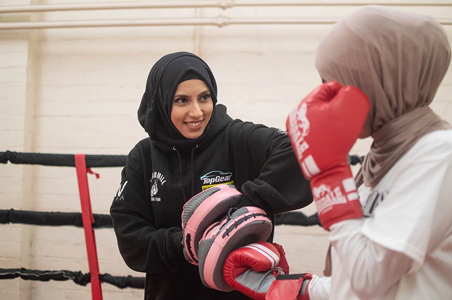 In this undated photo, Haseebah Abdullah trains with a fellow hijab-wearing boxing trainee at the Windmill Boxing Gym. (Supplied)
