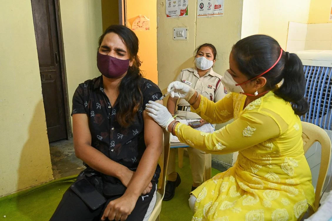 A health worker inoculates a transgender person with a dose of the Covishield vaccine against the Covid-19 coronavirus at a vaccination centre in New Delhi on June 23, 2021. (AFP)
