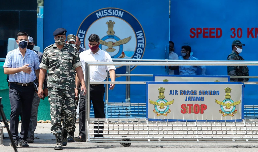 Indian paramilitary officials come out of the Jammu air force station after two suspected blasts were reported early morning in Jammu, India, Sunday, June 27, 2021. (AP)