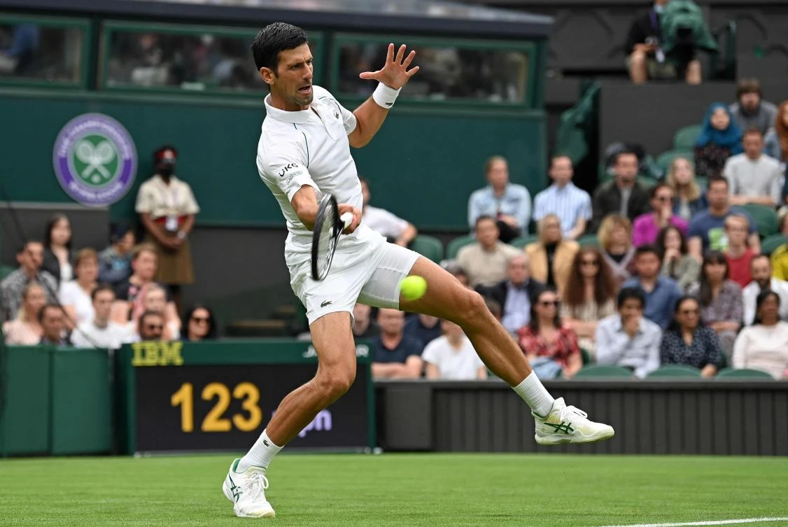 Serbia’s Novak Djokovic returns against Britain’s Jack Draper during their men’s singles first round match on 2021 Wimbledon Championships’ 1st day at The All England Tennis Club in Wimbledon. (AFP)