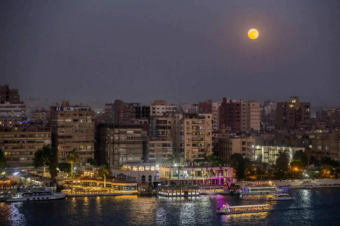 The moon rises above the Egyptian capital Cairo where a number of new stock listings are in the works. (AFP)