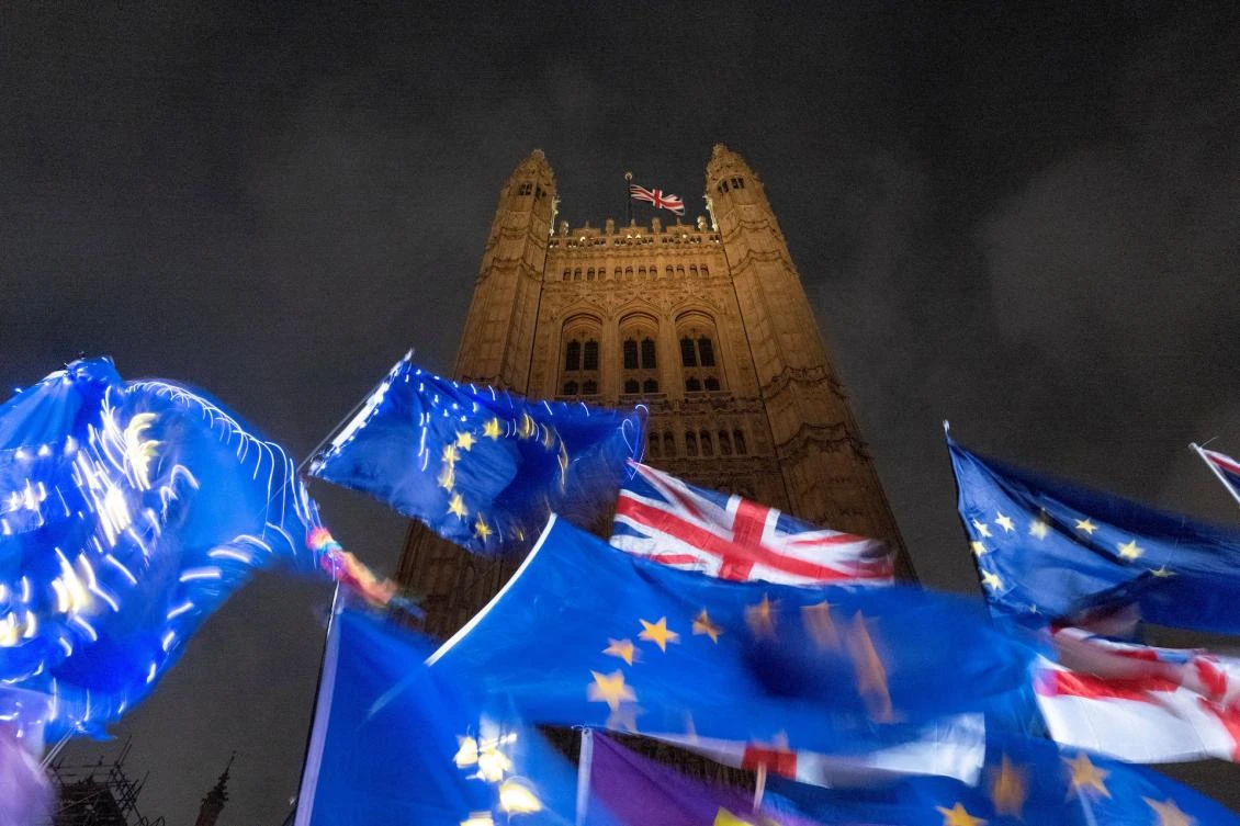 EU and Union flags flutter in the breeze as pro and anti-Brexit demonstrators protest outside of the Houses of Parliament in central London. (File/AFP)
