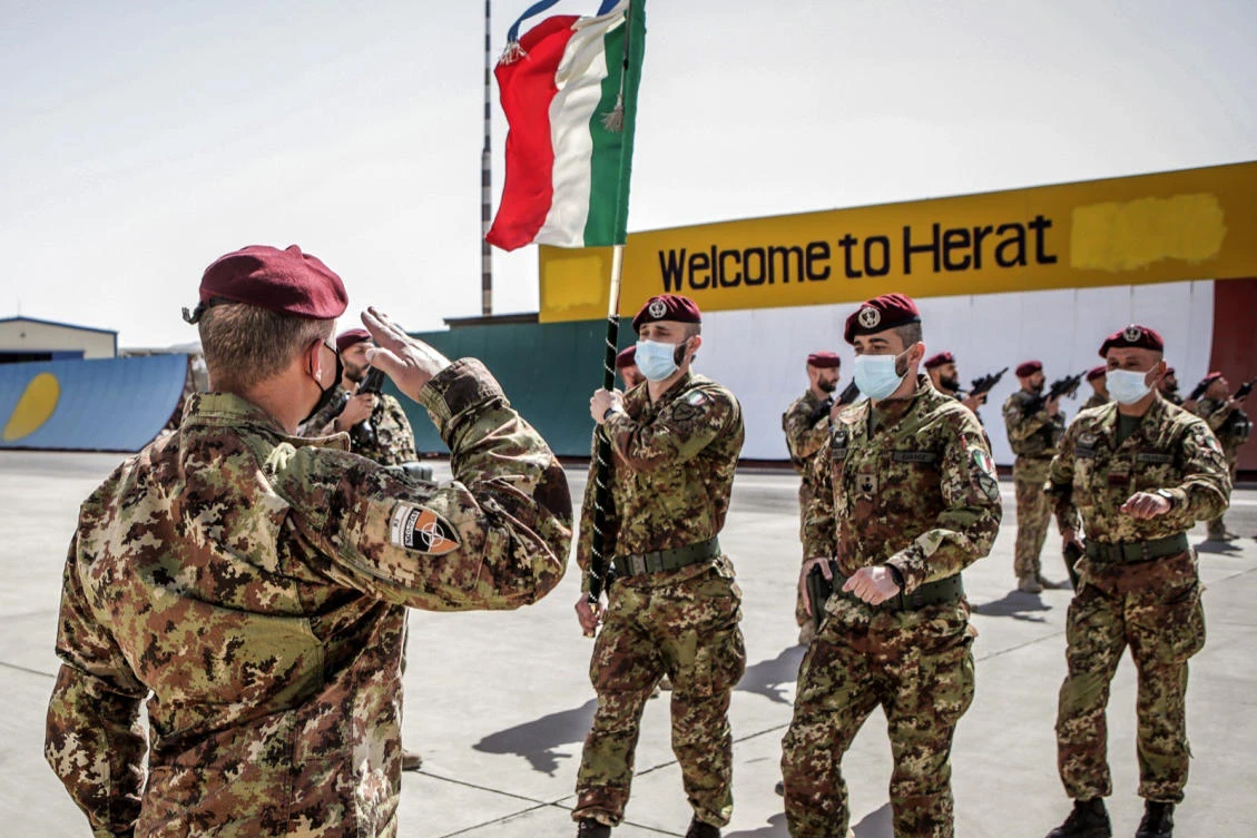 Italian Army soldiers carry Folgore Brigade flag as the last Italian troops withdraw from Afghanistan. The last German and Italian troops returned home from Afghanistan to low-key receptions nearly 20 years after the first soldiers were deployed. (AP)
