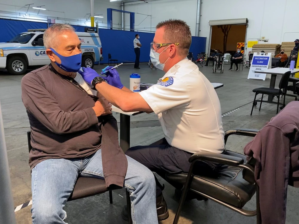Jose Luis Espinoza receives a dose of the Pfizer vaccine after waiting for a leftover one at a clinic in Santa Fe Springs, California, Feb. 2, 2021. (Reuters)