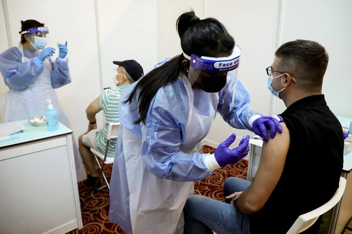 People receive AstraZeneca’s COVID-19 vaccine at a vaccination centre in Kuala Lumpur, Malaysia, May 5, 2021. (Reuters)