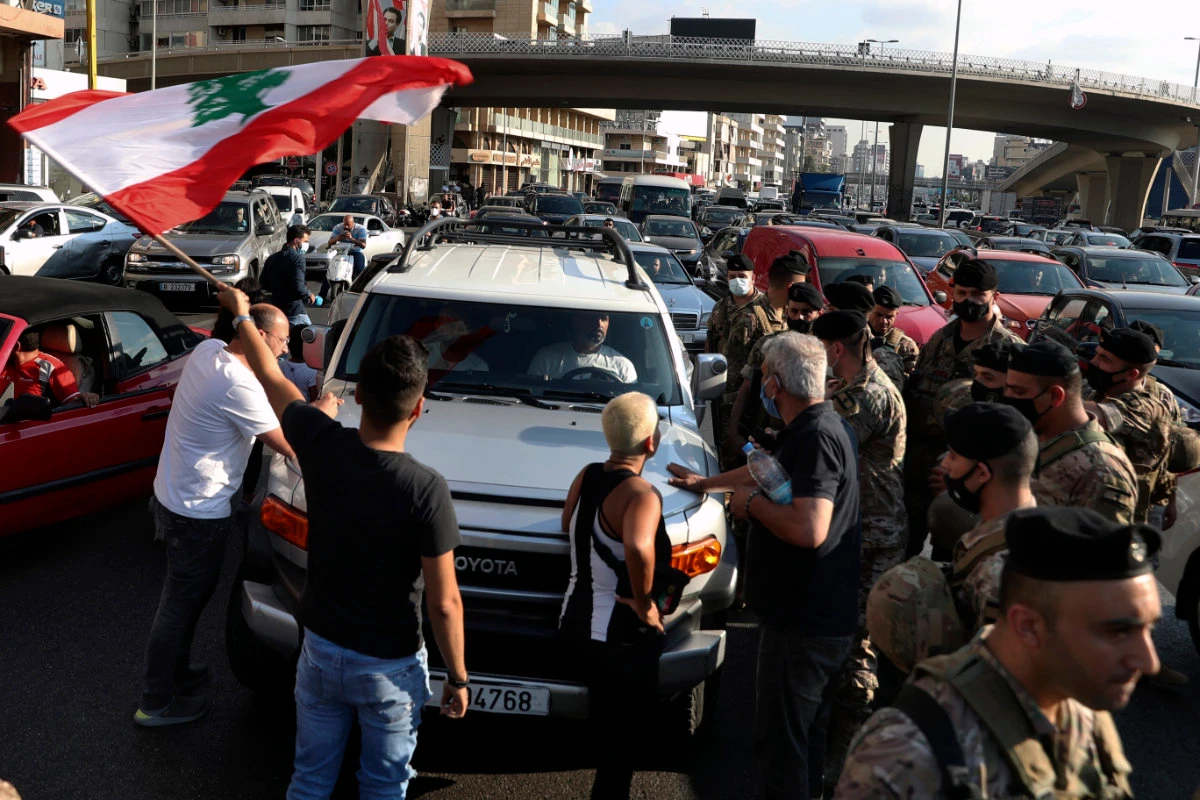 Lebanese army soldiers stand guard as protesters block a main highway leading to Beirut, Lebanon, on June 24, 2021. (AP Photo/Bilal Hussein)