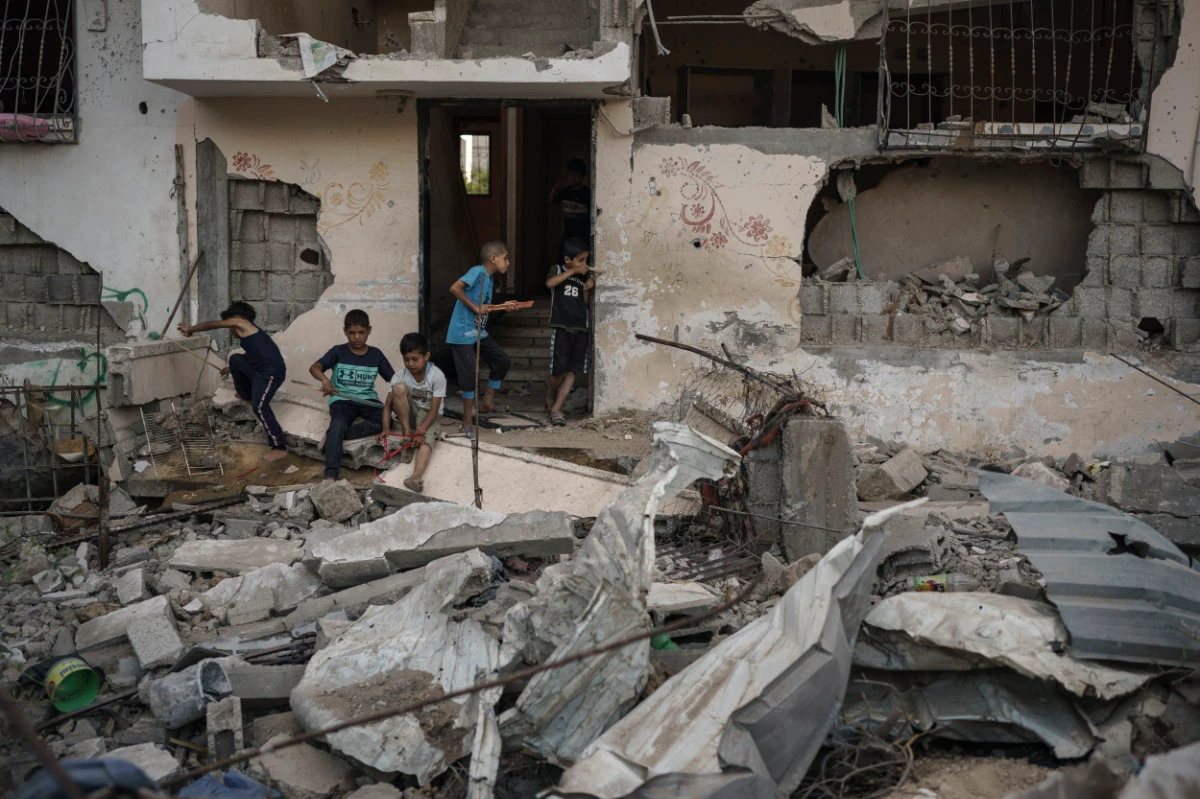 Palestinian children play among the rubble of homes in Beit Hanoun, Gaza Strip, that were destroyed by airstrikes during an 11-day war between Gaza's Hamas rulers and Israel. (AP File Photo)
