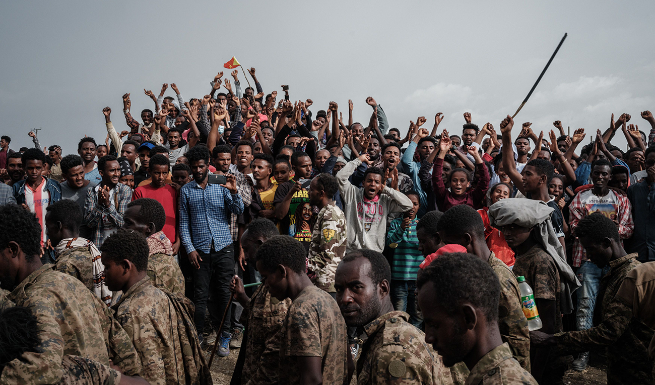 People react as captive Ethiopian soldiers walk towards Mekele Rehabilitation Center in Mekele, the capital of Tigray region, Ethiopia, on July 2, 2021. (AFP)
