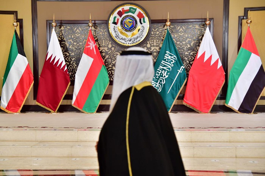 A man walks past the flags of the countries attending the Gulf Cooperation Council summit at Bayan palace in Kuwait City. (AFP/File)
