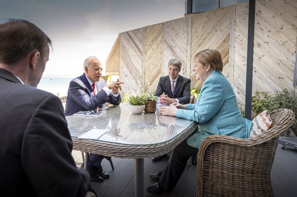 German Chancellor Angela Merkel (R) and US President Joe Biden (2nd L) at the beginning of a meeting on the sidelines of the G7 summit. (File/AFP)