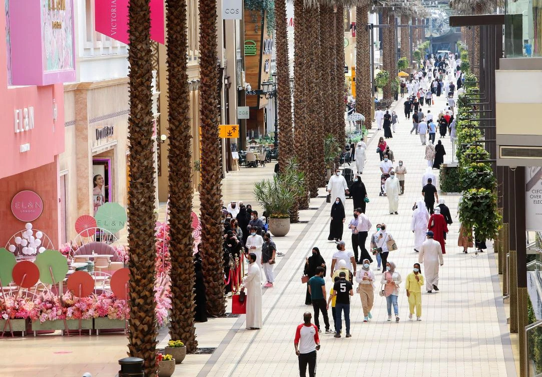 Kuwaitis wearing face masks walk in The Avenues Mall in Kuwait City, the country's largest shopping center. (AFP)