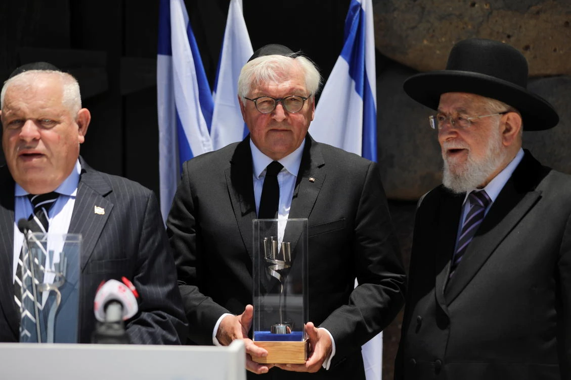 German President Frank-Walter Steinmeier receives a gift after taking part in a wreath-laying ceremony commemorating the six million Jews killed by the Nazis in the Holocaust, at Yad Vashem World Holocaust Remembrance Center, in Jerusalem. (Reuters)