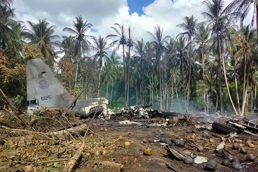 Smoke billows from the wreckage of a Philippine air force C-130 transport plane after it crashed near the airport in Jolo town, Sulu province on the southern island of Mindanao. (AFP)
