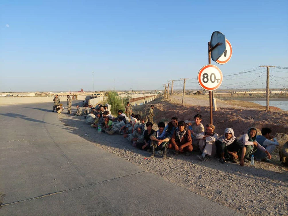 Afghanistan’s government soldiers sit at a bridge next to Tajikistan-Afghanistan border in Tajikistan. Afghan security personnel fled into Tajikistan after Taliban advanced in northern Afghanistan. (AP)
