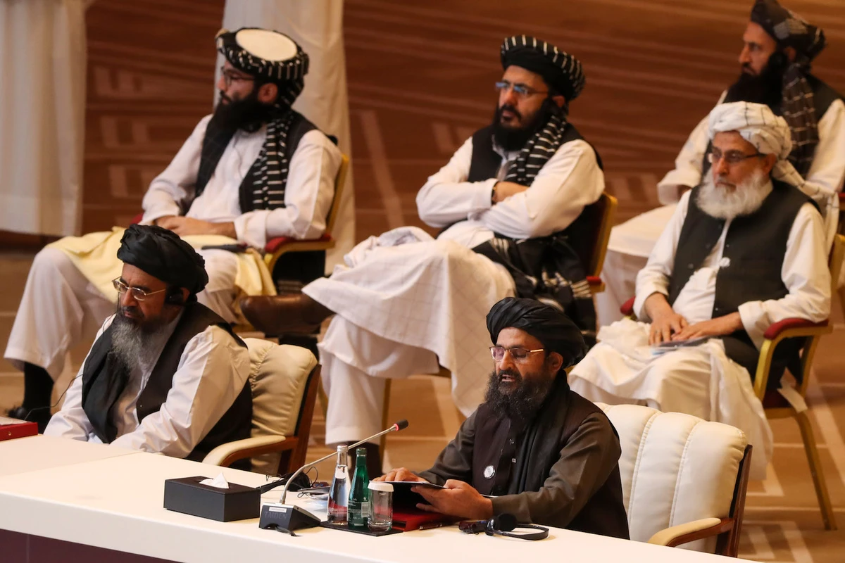 Taliban co-founder Mullah Abdul Ghani Baradar (R, bottom) speaks during the opening session of the peace talks between the Afghan government and the Taliban in Doha, Qatar, on September 12, 2020. (AFP/File)