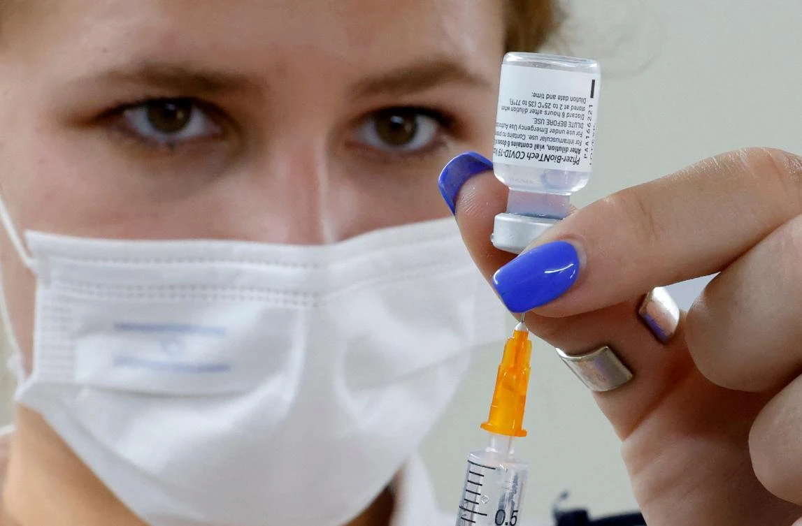 An Israeli medical worker prepares a dose of the Pfizer/BioNTech COVID-19 vaccine during a campaign to encourage the vaccination of teenagers on July 5, 2021, in Tel Aviv. (AFP)