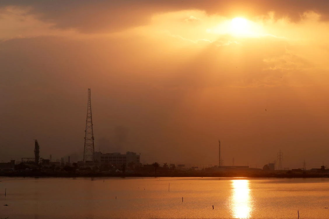 General view of factories of cement and petroleum by a salt lake at sunset near the port the Mediterranean city of Alexandria, north of Cairo. (Reuters)