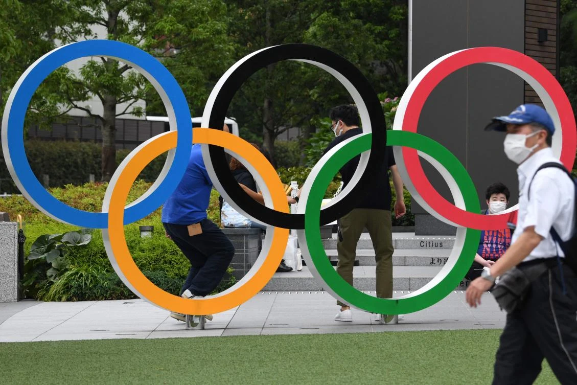 Olympic rings displayed near the National Stadium, main venue for the Tokyo 2020 Olympic and Paralympic Games on Wednesday as reports said the Japanese government will impose a virus state of emergency during Olympics. (AFP)
