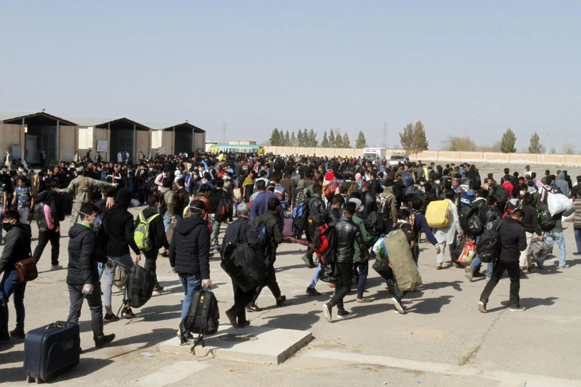 Thousands of Afghan refugees walk as they enter Afghanistan at the Islam Qala border crossing with Iran, in the western Herat Province on March 18, 2020. (File/AP)