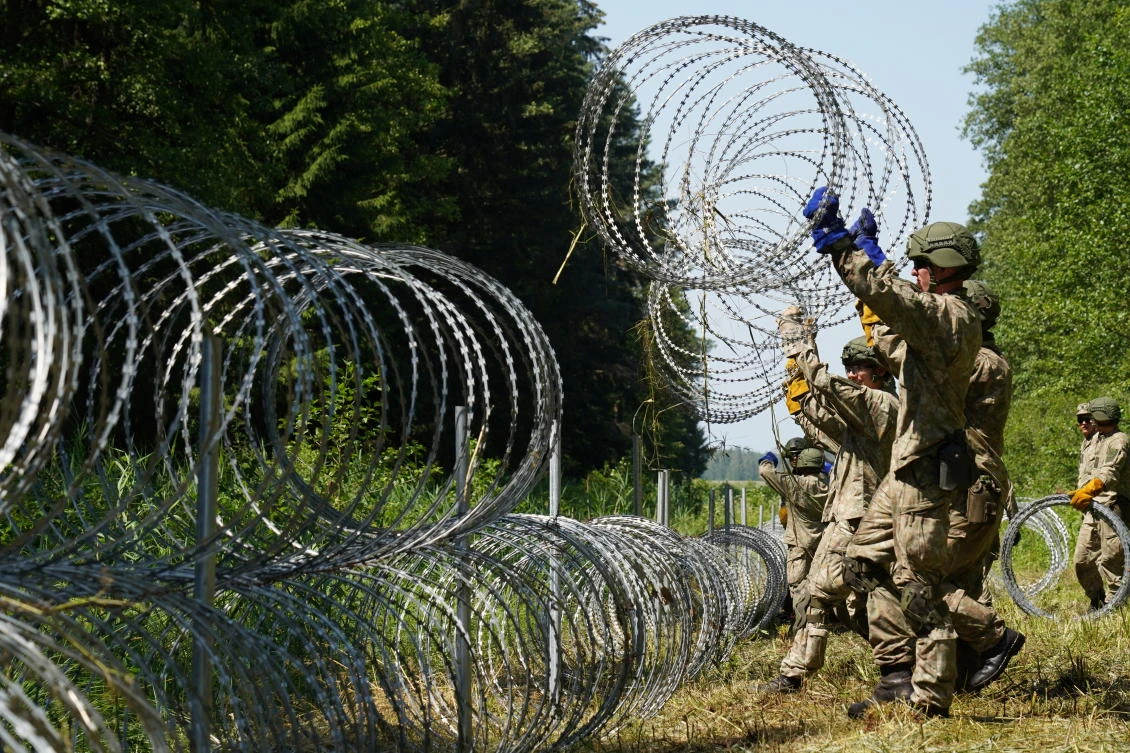 Lithuanian army soldiers install razor wire along the border with Belarus, Druskininkai, Lithuania, July 9, 2021. (Reuters)