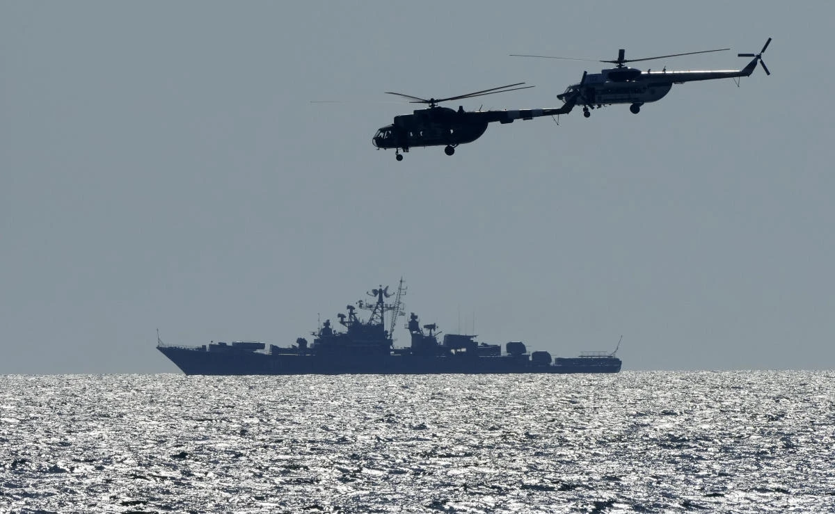 Ukrainian helicopters fly over a Russian warship  during Sea Breeze 2021 maneuvers, in the Black Sea, Friday, July 9, 2021. (AP)