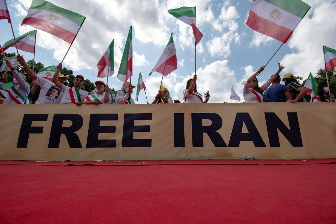 Demonstrators take part in a protest called by the National Council of Resistance of Iran (NCRI) against the Iranian regime in front of the Brandenburg Gate in Berlin on July 10, 2021. (AFP)