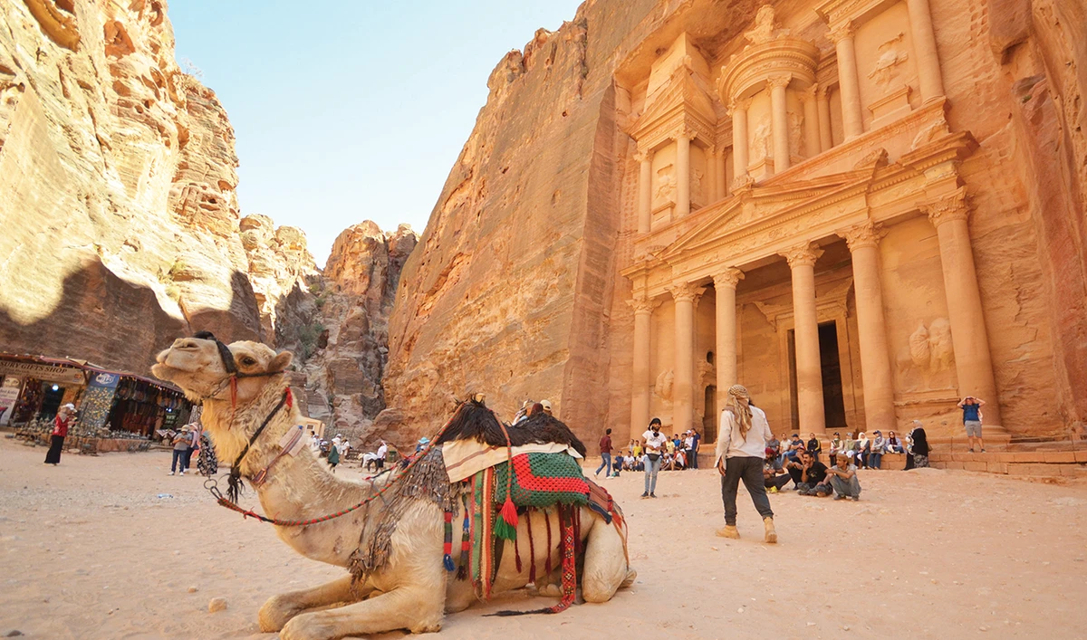 Tourists gather in front of the treasury site in the ancient city of Petra in Jordan on July 2. Foreign tourists are starting to trickle back. (Reuters)