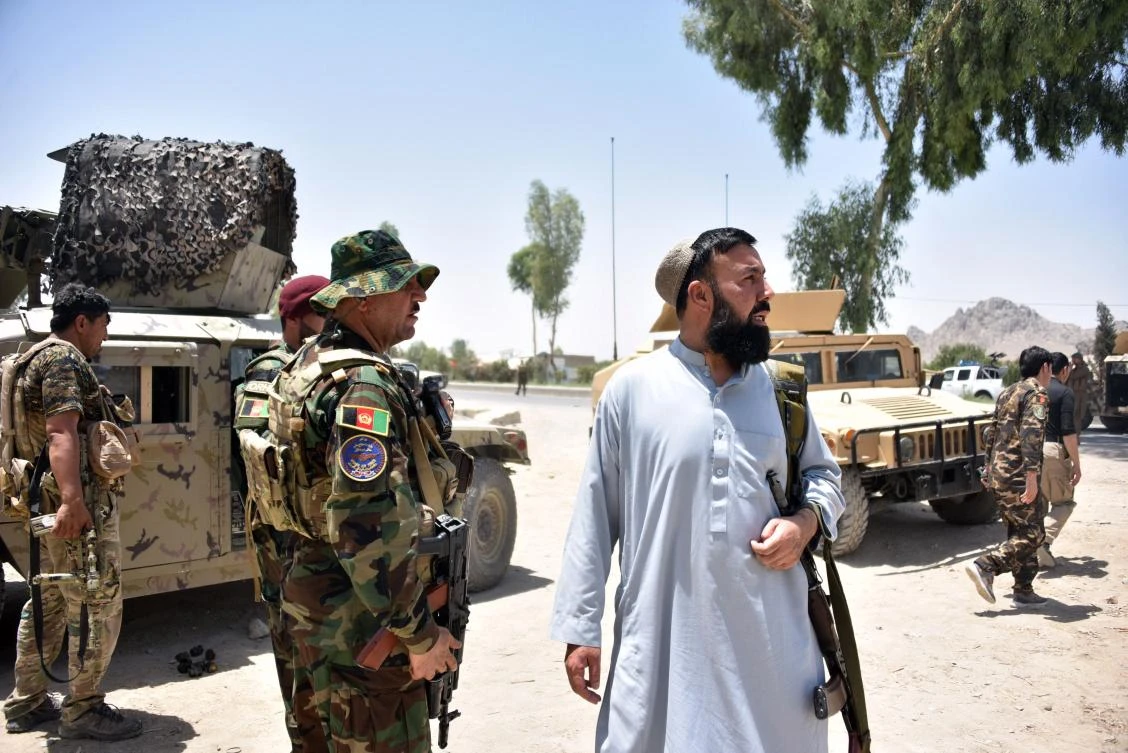 Afghan security personnel stand guard along the road amid ongoing fights between Afghan security forces and Taliban fighters in Kandahar on July 9, 2021. (AFP)
