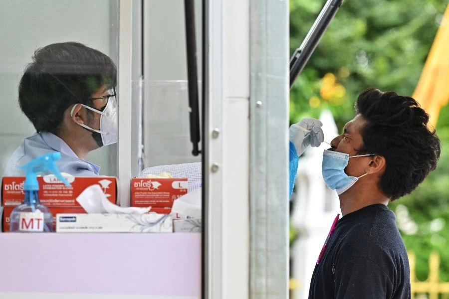 A health worker administers a swab test for the Covid-19 coronavirus at Wat Phra Sri Mahatat Buddhist temple in Bangkok on July 8, 2021. (File/AFP)