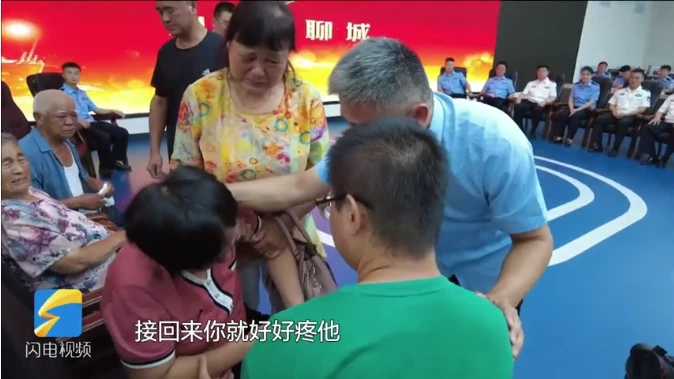 Screenshot taken from a video released by state-run China News Service showing Guo Gangtang, his wife and their son, Guo Zhen, during the reunion event. (Screengrab)
