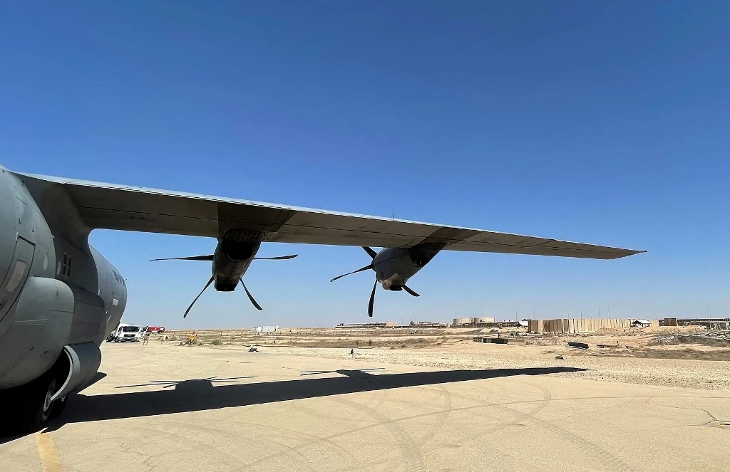 A military transport aircraft on the runway at Ain al-Assad air base last week, a day after 14 rockets were fired at the base. (AFP)