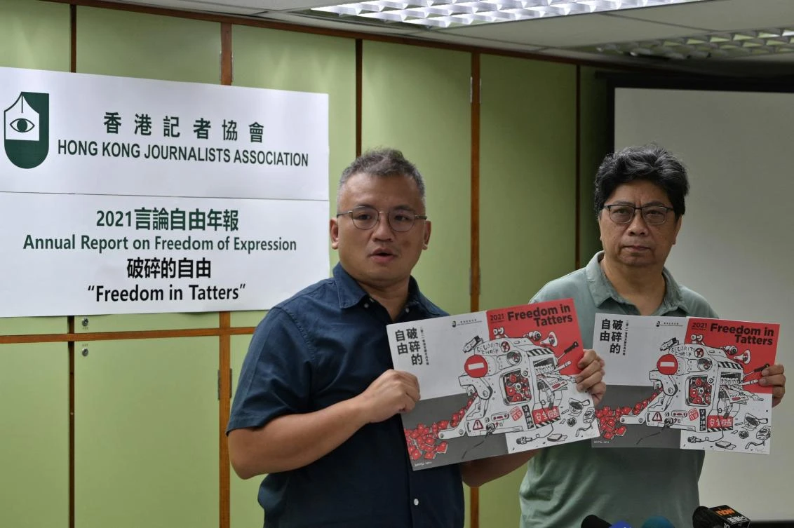 Chairperson of the Hong Kong Journalists Association (HKJA) Ronson Chan (L) and Chris Yeung, chief editor of the annual report, during the unveiling of the report “Freedom in Tatters” in Hong Kong on July 15, 2021. (AFP)