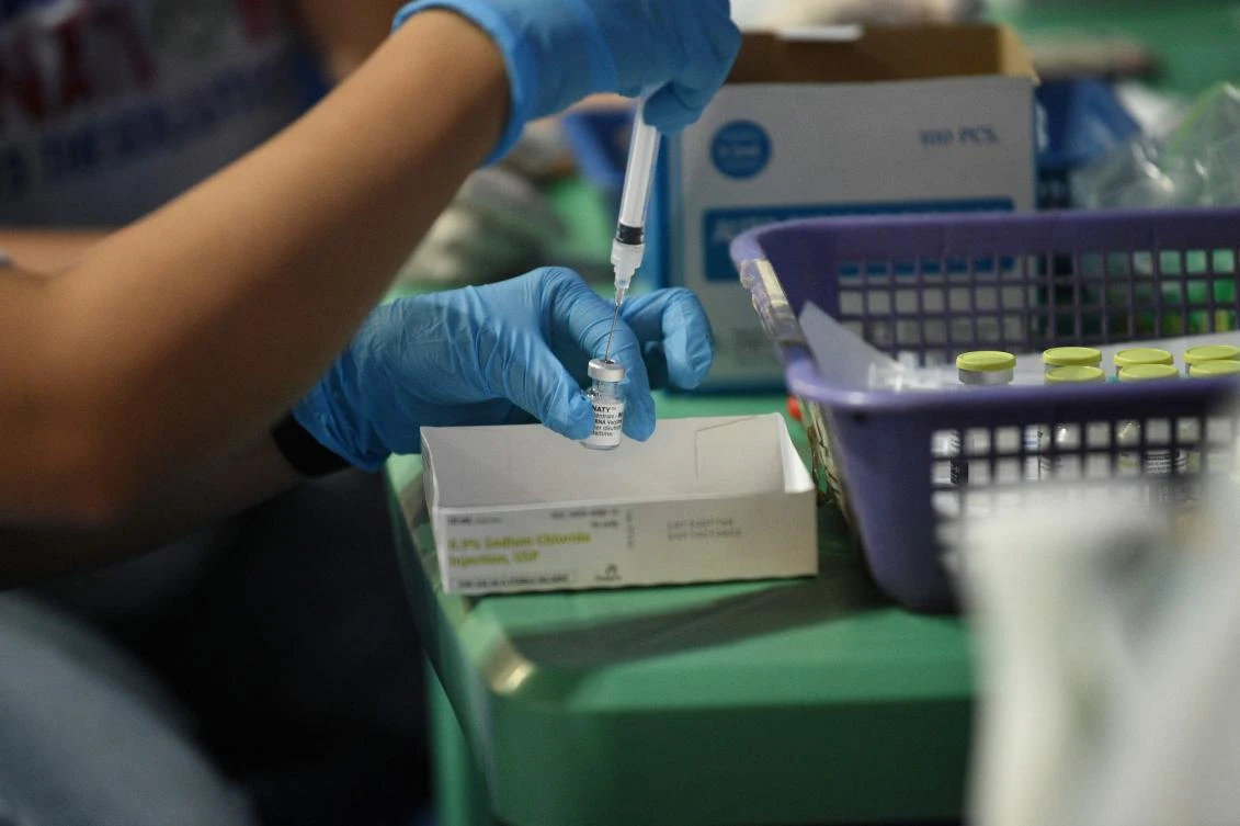 A health worker prepares a dose of the BioNtech Pfizer Covid-19 vaccine during a vaccination for seafarers at a stadium in Manila on July 15, 2021. (AFP)