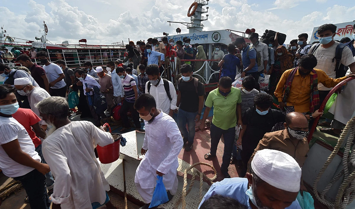 People disembark from a passenger ferry after the government eased a lockdown imposed as a preventive measure against the Covid-19 coronavirus ahead of the Muslim festival of Eid al-Adha in Sreenagar on July 15, 2021. (AFP)