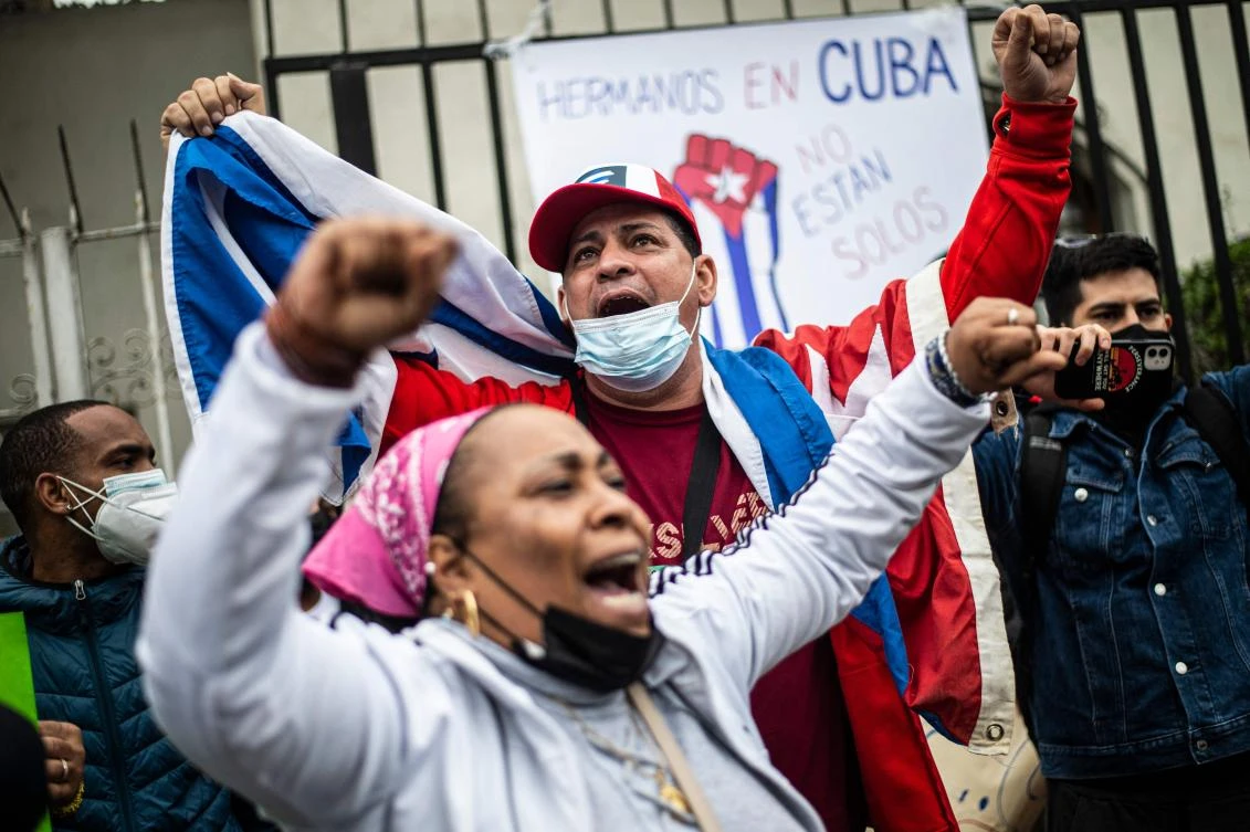 Cuban citizens residing in Peru demonstrate against the Cuban government of President Miguel Diaz-Canel outside the Cuban Embassy in Lima, on July 13, 2021. (AFP)
