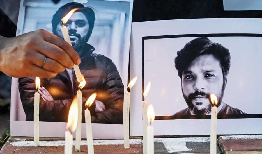 Candles are placed by journalists next to the portrait of Reuters photojournalist Danish Siddiqui as a tribute in Kolkata on Friday. (AFP)