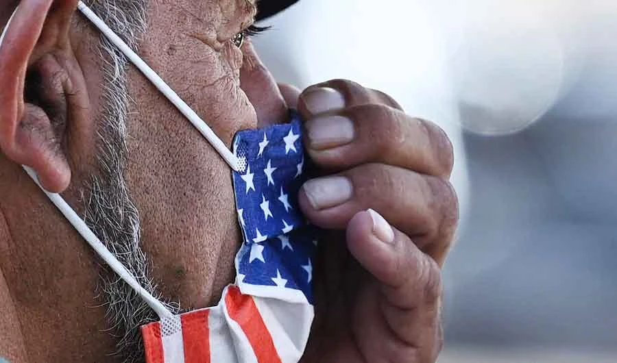 A man adjusts his American flag face mask on July 19, 2021 on a street in Hollywood, California. (AFP file photo)