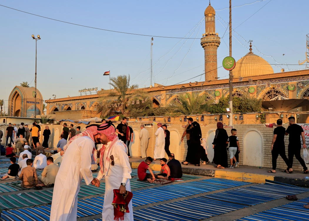 Iraqi worshippers exchange Eid Al-Adha greetings in Baghdad. (Reuters)