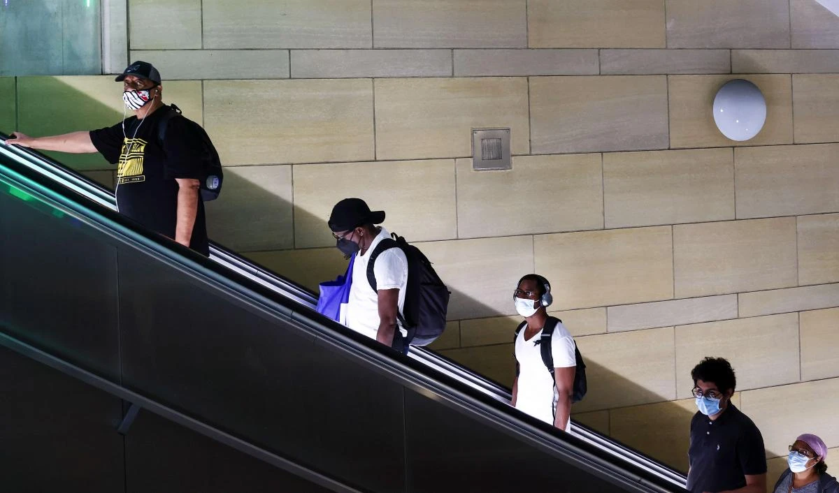 Wearing of masks is again mandatory in Los Angeles after a spike in cases worlwide that is weighing on oil prices. (AFP)