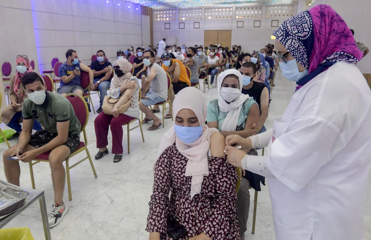 A Tunisian woman receives a dose of the Chinese Sinopharm vaccine at the Palais des Congres in the capital Tunis. (AFP)