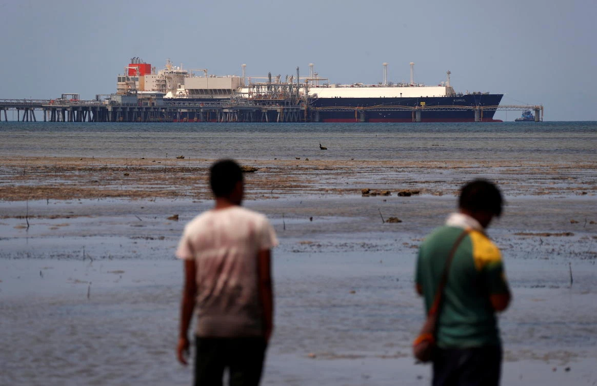 An LNG carrier is docked at marine facility of ExxonMobil in Port Moresby. Exxon shareholders elected two new climate-conscious board members. (Reuters)